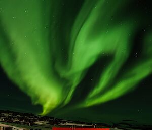 Twisting auroral bands of green above Mawson station