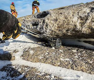 an anchor is wedged under a rock