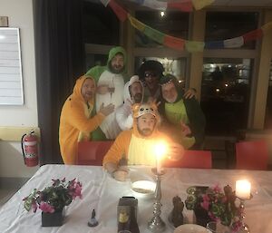 6 men dressed in animal costumes are taking a selfie photo