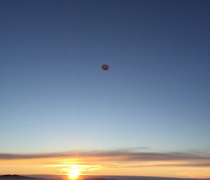 A balloon flies above the sea ice