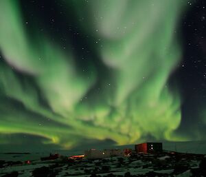 White vapours glow above different coloured buildings