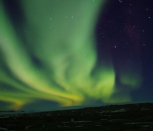 Green and white vapors appear to rise from a white plateau