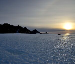 Frozen ice in front of a jagged mountain range