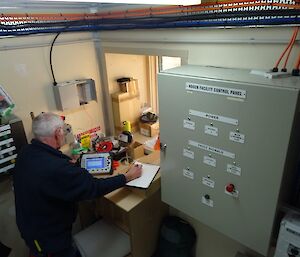 A man stands in front of technical equipment