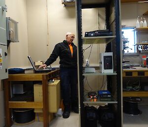 A man stands in front of technical equipment