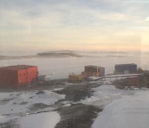 Buildings and a frozen harbour in the background