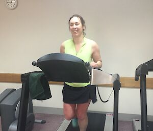 A woman is running on a treadmill