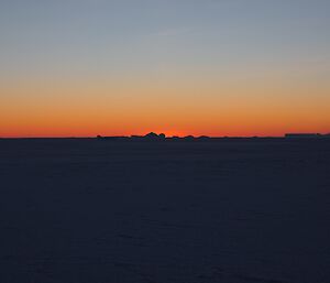An orange Sunrise over the sea ice at Mawson