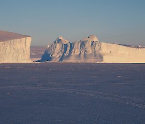 Icebergs on the horizon in pink light