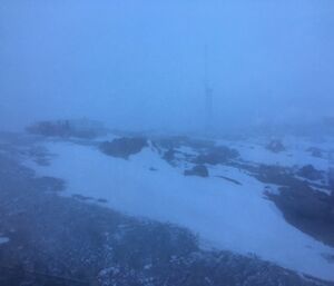 A blizzard obscures the visibility of buildings