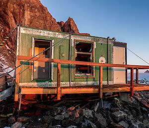 A green hut with no window or door