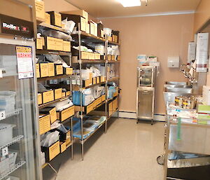 An empty medical scrub area with shelves of medical supplies.