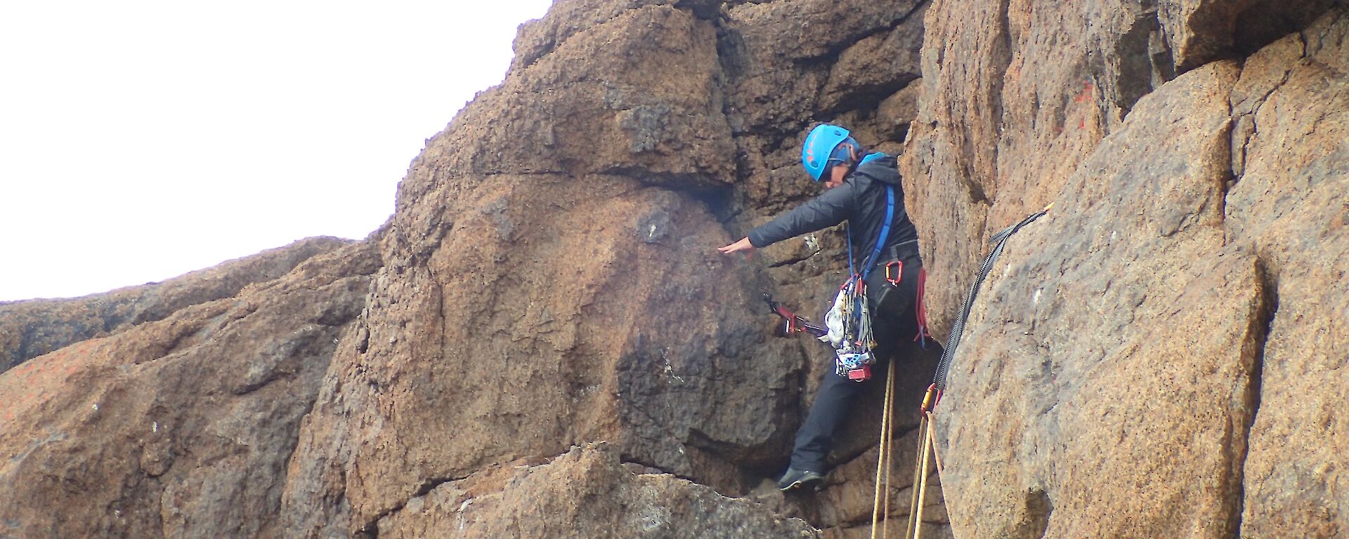 A woman is mountain climbing.