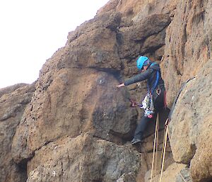 A woman is mountain climbing.