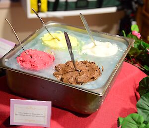 Four frozen sorbet ice creams in a block of ice.