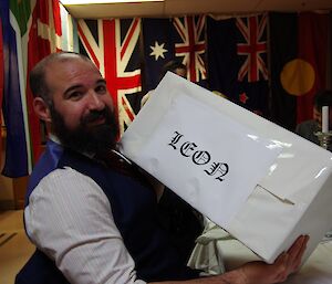 A man holds a big white box.