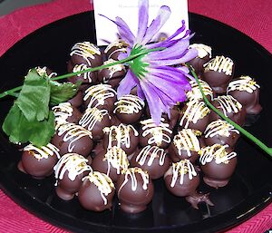 Chocolates are arranged on a platter.