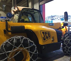 A yellow telehandler machine.