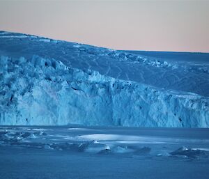 A tide crack in front of a blue glacier edge.