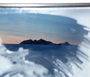 A mountain range taken from the interior of a vehicle