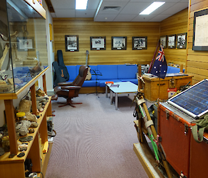 A wood panelled room with photos and memorabilia on display
