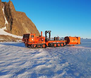 The red pioneer and orange van on ice in front of Rumdoodle peak