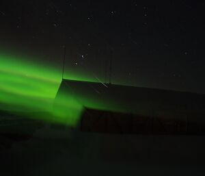 A green aurora shines into a building on station.