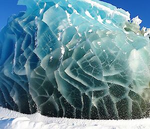 A jade iceberg of blue and green shines in the sunshine