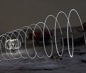 Light swirls appear across a snowy landscape