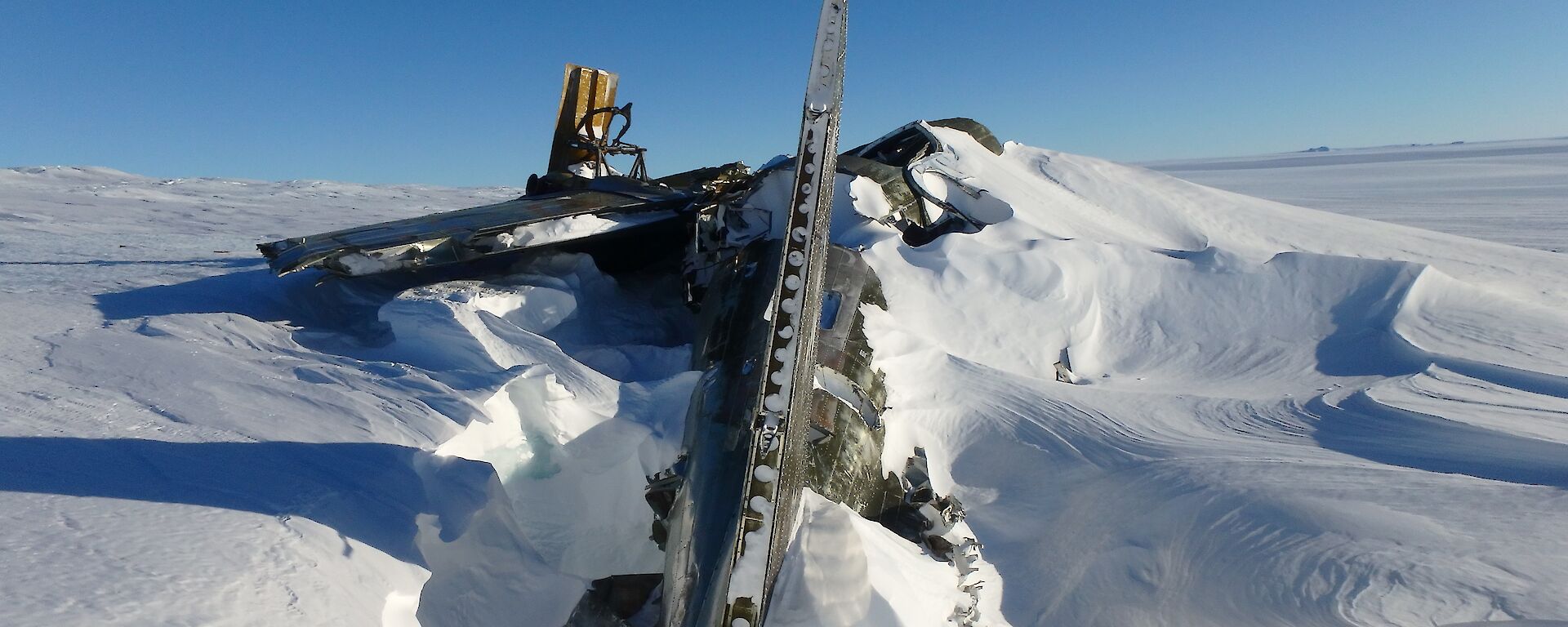 The remnants of a plane wreck embedded in snow and ice