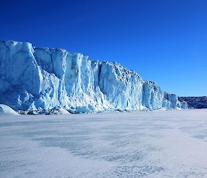 Blue glacier cliffs with a big blue sky in the background