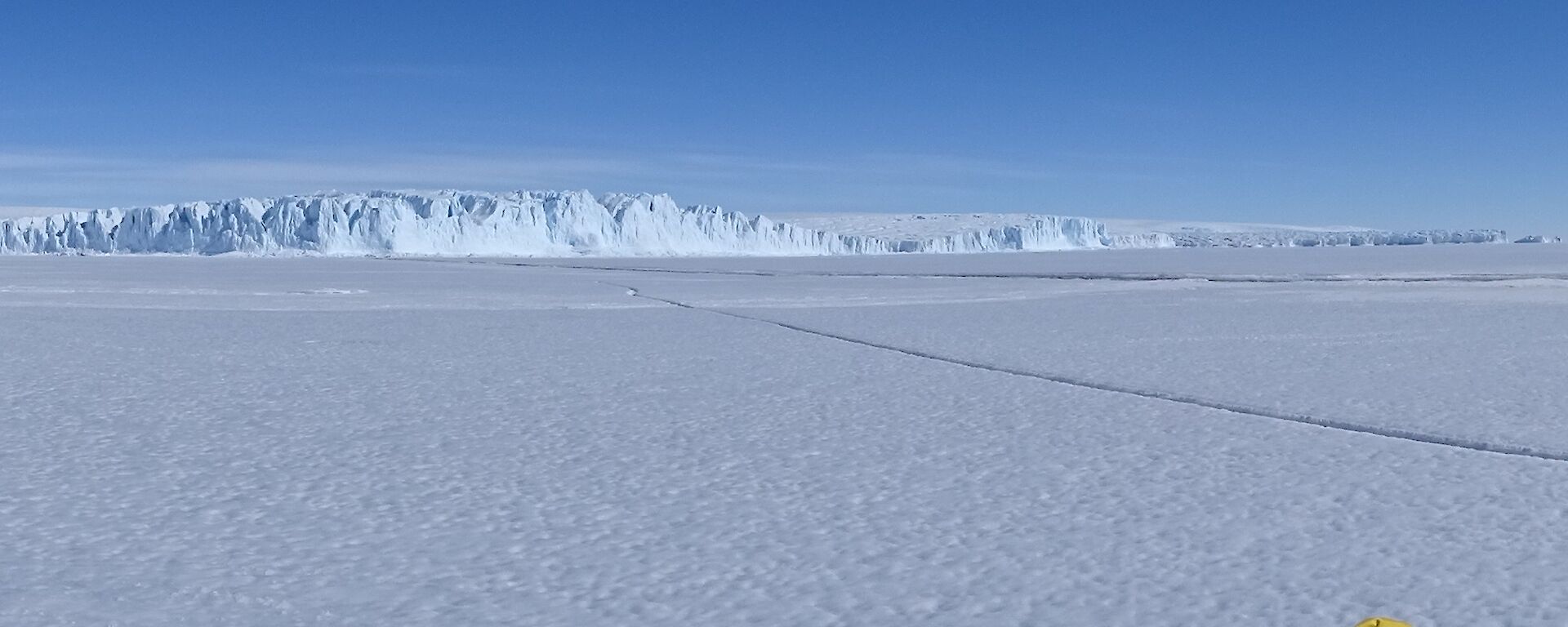 An ice cliff edge of the Antarctic plateau meets the sea ice.