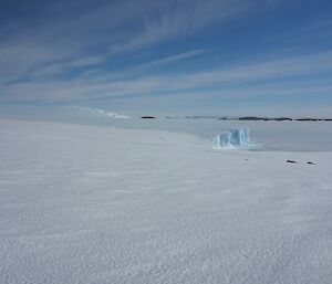 A sea ice cliff edge with islands frozen into sea ice.