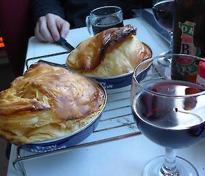 Two warm pies and a glass of wine.
