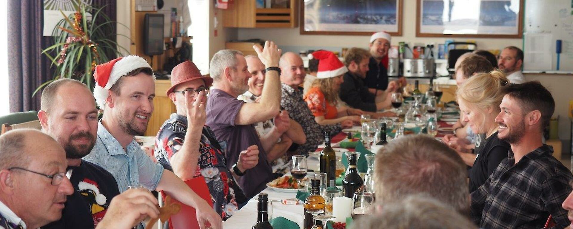 A group of people around a long table for Christmas lunch