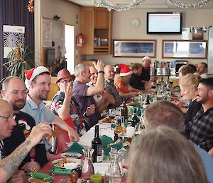 A group of people around a long table for Christmas lunch