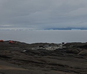 A view over Bechervaise island to the icebergs on the horizon