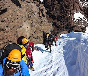 A line of people climbing up Mt Hordern through the snow