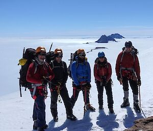 5 happy climbers on the mountain