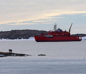 The ship sits just offshore in Kista Strait ready to move personnel