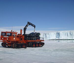 2 IRBs on the back of a Pioneer truck in front of a bay and snow cliff