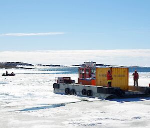 A barge in the harbour trying to break up the sea ice