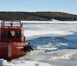 A workboat helping to break up ice in the harbour