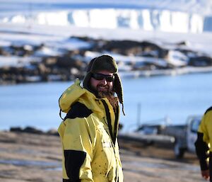 A man in his survival clothing looking at camera