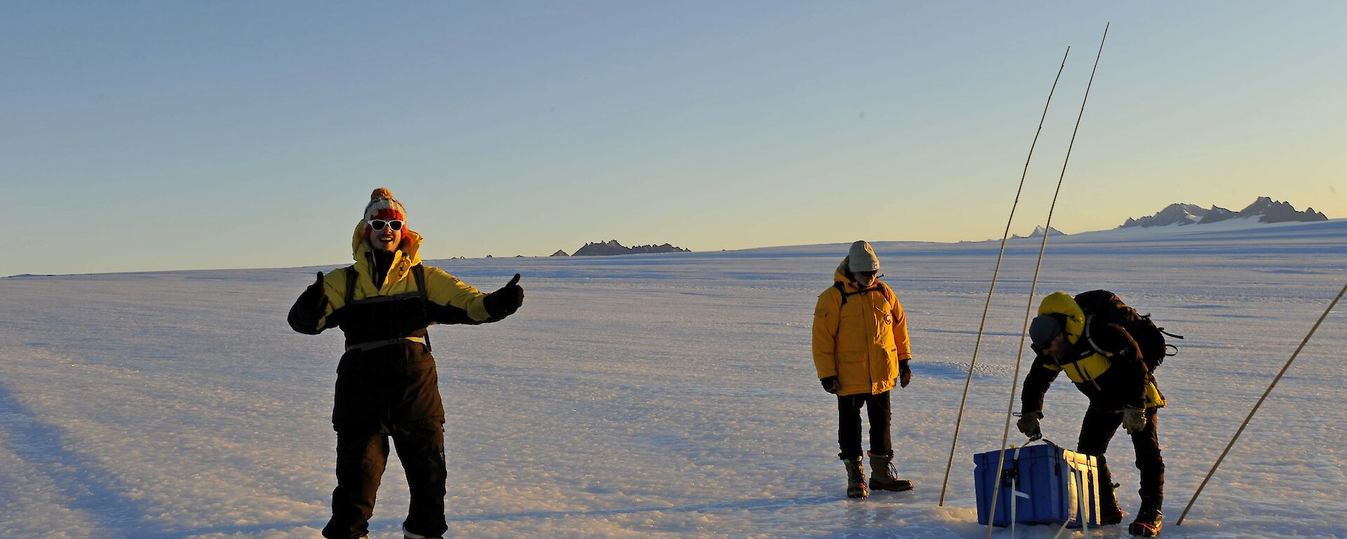 3 men on the plateau checking an emergency cache