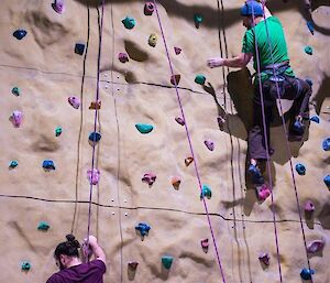 2 men on a climbing wall