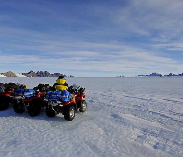 4 quad bikes lined up on the icy plateau