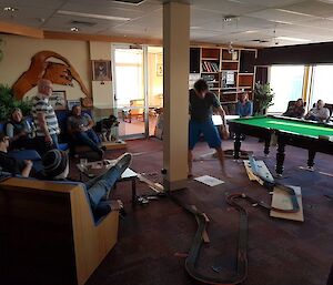 A group of people around a slot car track