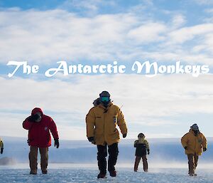 Six men walk towards camera across the ice