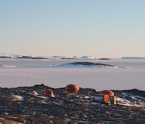 The huts on Béchervaise Island with iceberg alley on the horizon